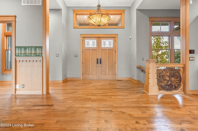 foyer featuring a chandelier and light hardwood / wood-style floors