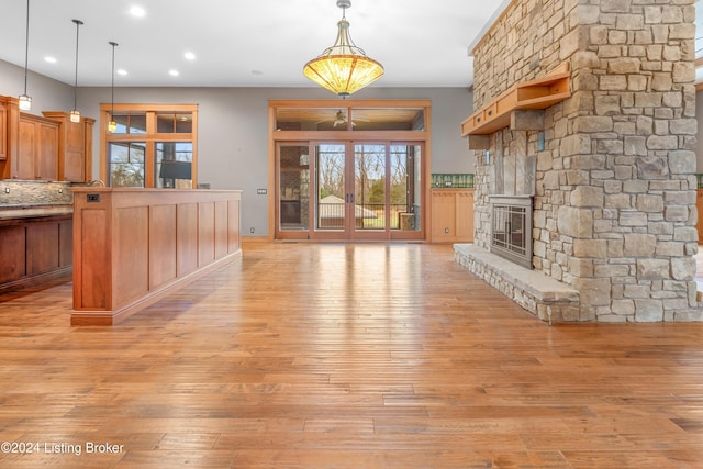 unfurnished living room with a fireplace and light hardwood / wood-style floors