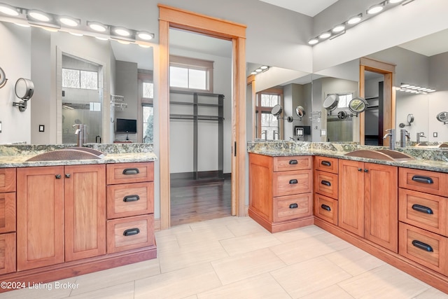 bathroom with hardwood / wood-style floors, vanity, and walk in shower