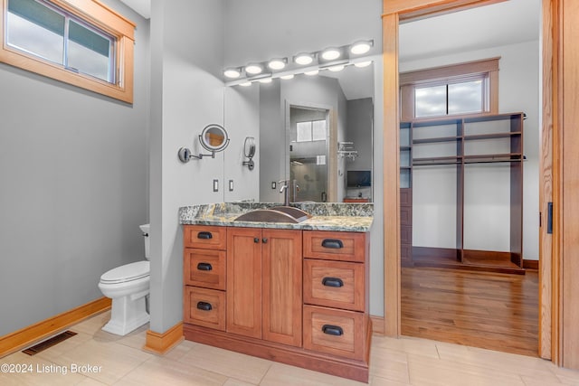 bathroom featuring hardwood / wood-style floors, vanity, and toilet