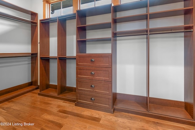 spacious closet with light hardwood / wood-style floors