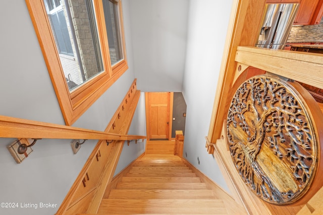 stairs featuring hardwood / wood-style floors