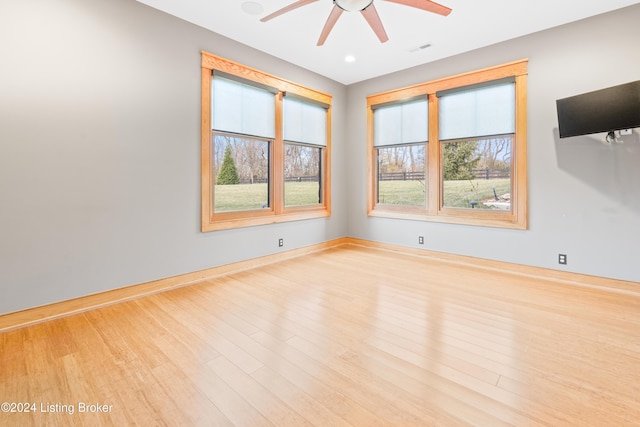 unfurnished room with ceiling fan and light hardwood / wood-style floors