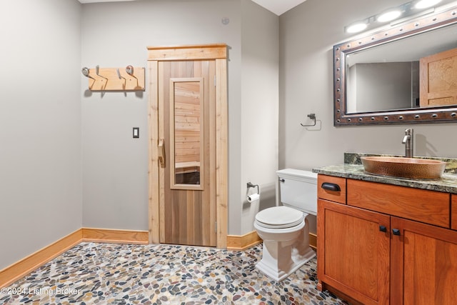 bathroom with tile patterned flooring, vanity, and toilet