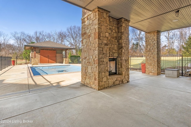 view of patio with an outdoor structure and a covered pool