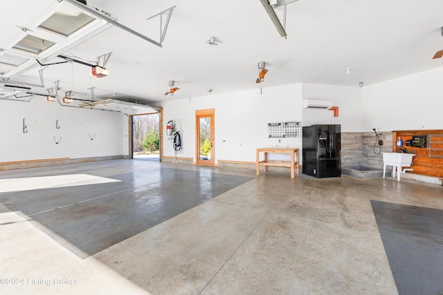 garage featuring black fridge with ice dispenser, sink, a garage door opener, and a wall mounted AC