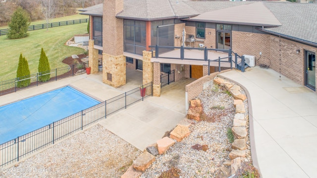 view of swimming pool with a lawn, a fireplace, and a patio