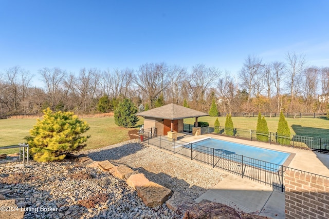 view of pool featuring a lawn, a patio area, a gazebo, and a rural view