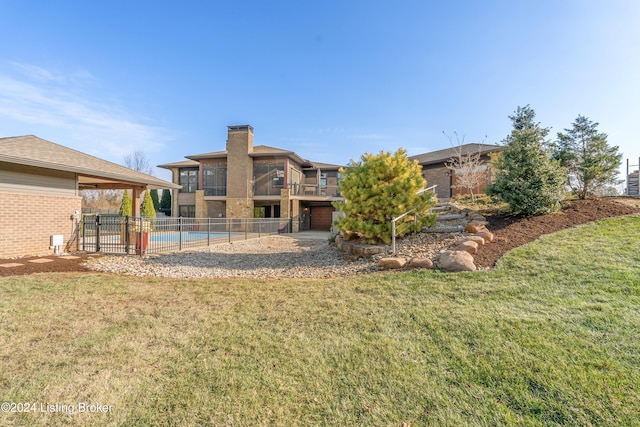 rear view of property with a lawn