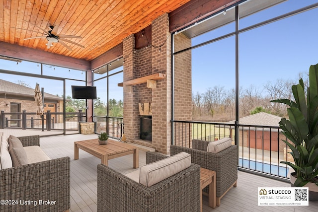 sunroom featuring ceiling fan and wood ceiling