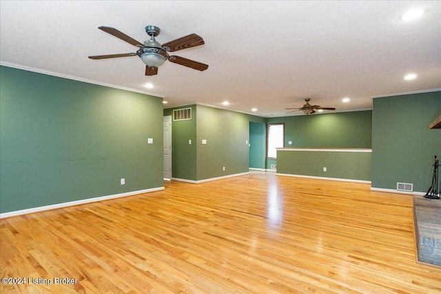 spare room featuring light hardwood / wood-style floors, ceiling fan, and crown molding