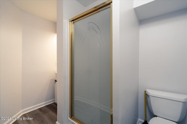 bathroom with a shower with door, wood-type flooring, and toilet