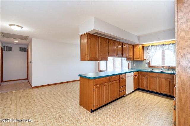 kitchen with white dishwasher, kitchen peninsula, and sink