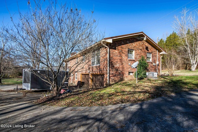 view of side of property featuring central AC