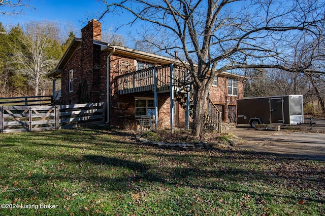 rear view of house featuring a yard