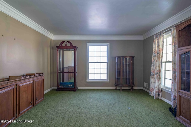 carpeted empty room featuring crown molding