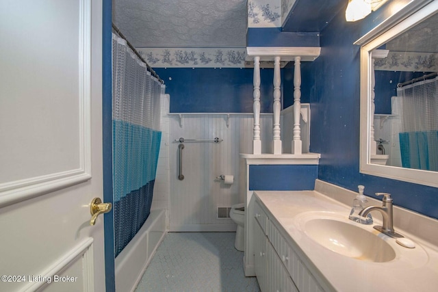 full bathroom with shower / tub combo, vanity, a textured ceiling, and toilet