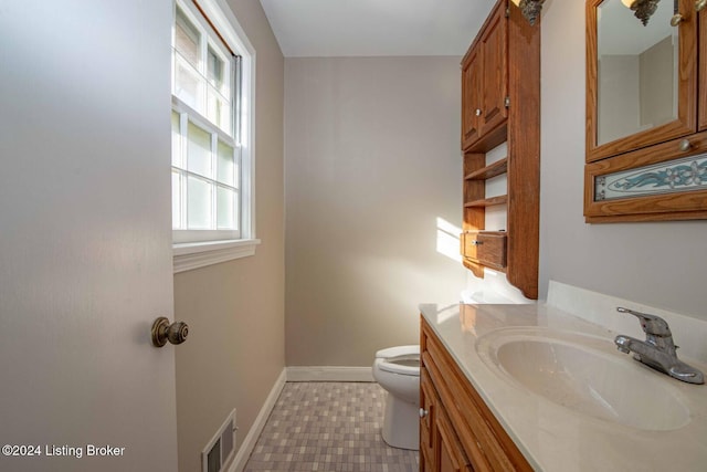 bathroom featuring vanity and toilet