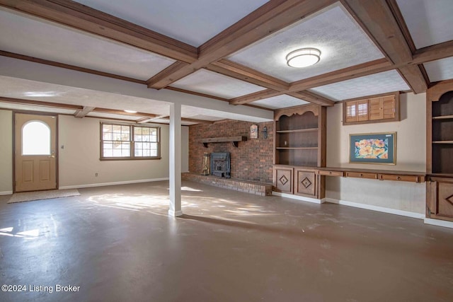 unfurnished living room with beam ceiling, a wood stove, concrete floors, and coffered ceiling