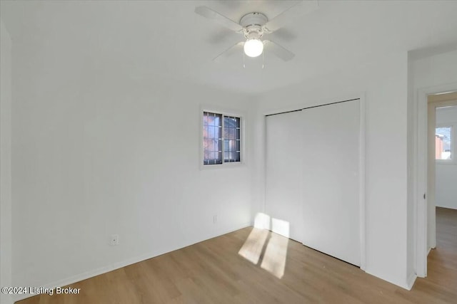 unfurnished bedroom with ceiling fan, light hardwood / wood-style floors, and a closet