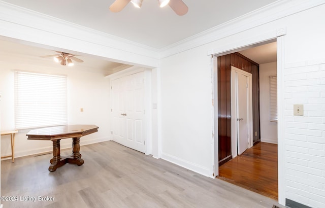 hall with light wood-type flooring and crown molding