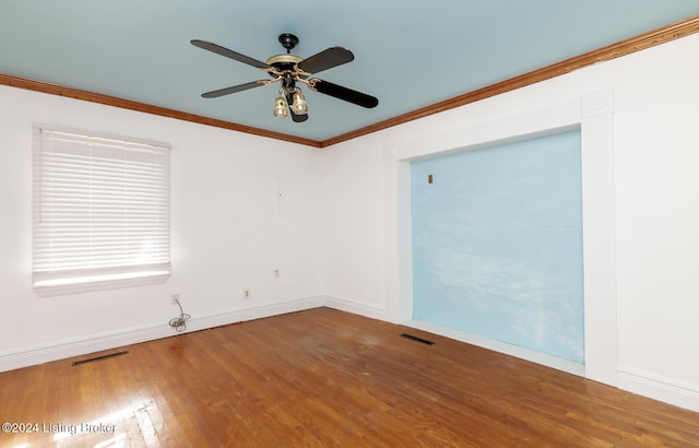 unfurnished room with hardwood / wood-style floors, ceiling fan, and crown molding