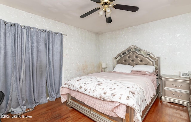 bedroom featuring dark hardwood / wood-style floors and ceiling fan