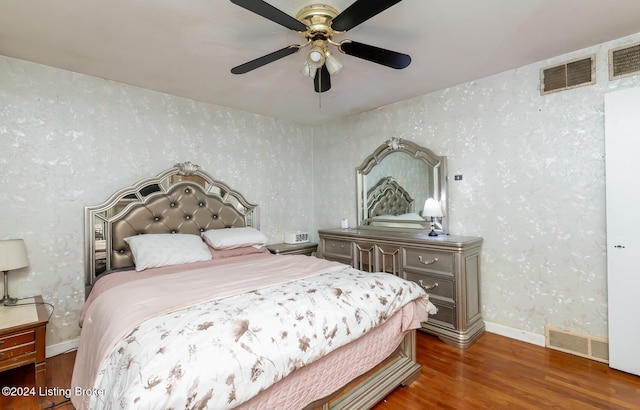 bedroom with ceiling fan and dark hardwood / wood-style floors