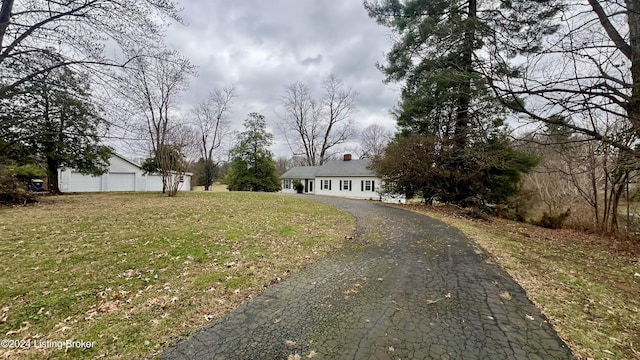 view of front of property with a front yard and a garage