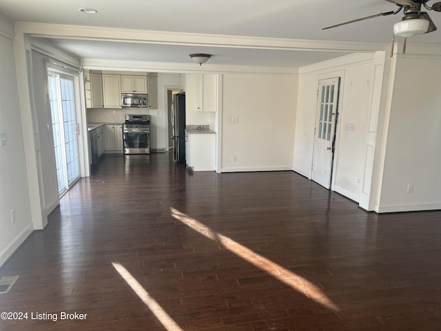 unfurnished living room with ceiling fan, ornamental molding, and dark wood-type flooring