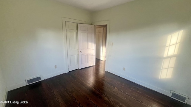 unfurnished room featuring dark hardwood / wood-style floors