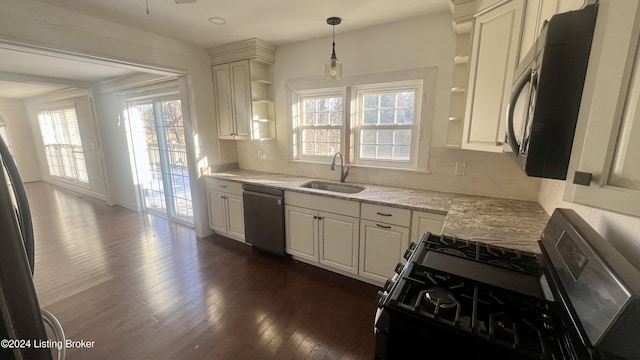 kitchen featuring dark hardwood / wood-style flooring, stainless steel appliances, a wealth of natural light, and sink