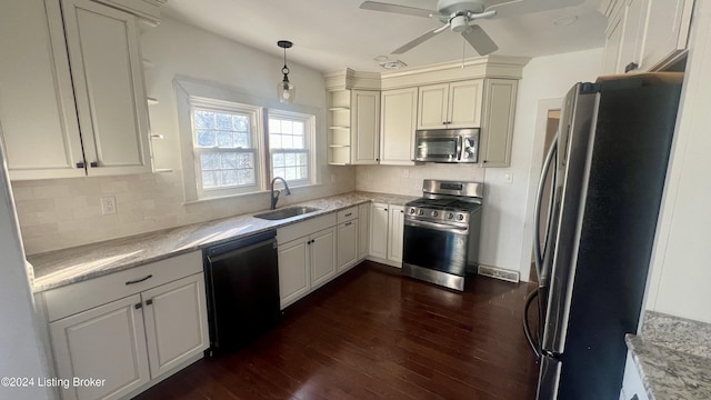 kitchen featuring stainless steel appliances, ceiling fan, sink, dark hardwood / wood-style floors, and hanging light fixtures