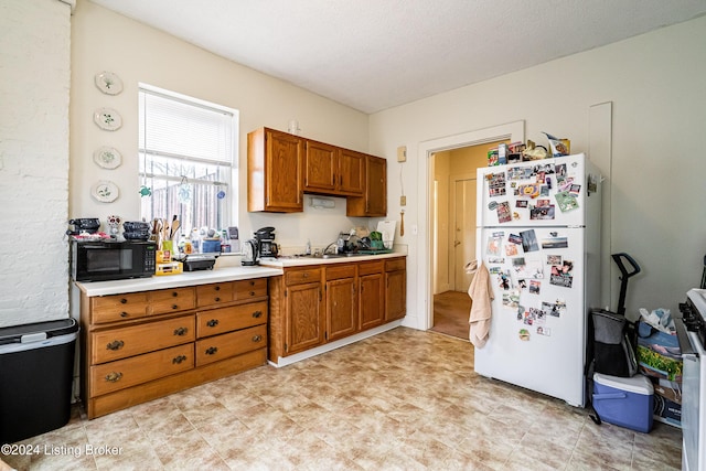 kitchen with white fridge and sink