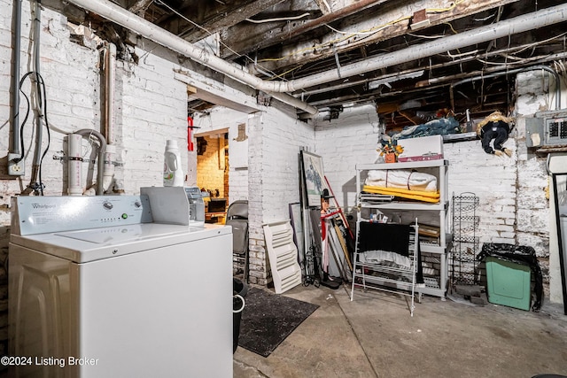 basement with washer / dryer and brick wall