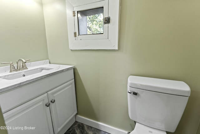 bathroom featuring vanity and toilet