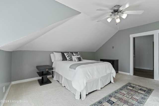 bedroom with carpet flooring, ceiling fan, and vaulted ceiling