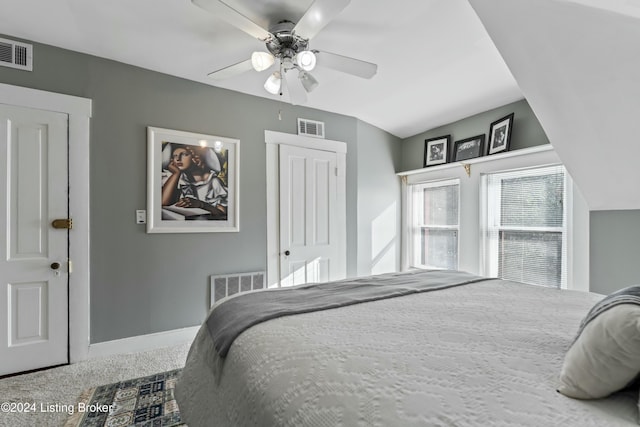 carpeted bedroom with ceiling fan and lofted ceiling