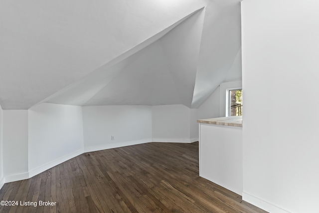 bonus room featuring dark hardwood / wood-style floors and lofted ceiling