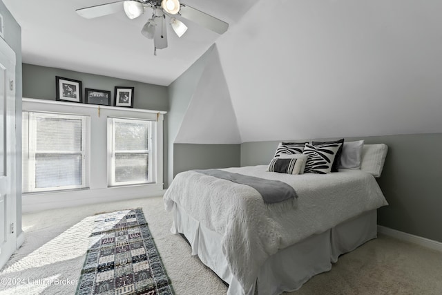 carpeted bedroom featuring ceiling fan and lofted ceiling