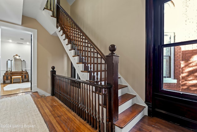 staircase with hardwood / wood-style floors