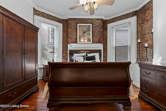 bedroom with dark hardwood / wood-style flooring, ceiling fan, crown molding, and brick wall