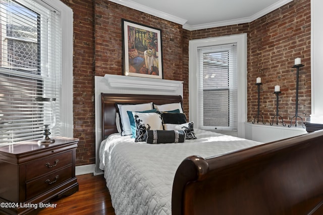 bedroom featuring dark hardwood / wood-style flooring, ornamental molding, and brick wall