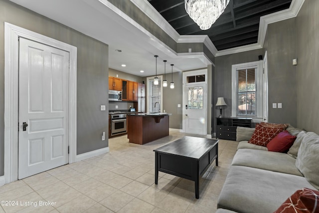 tiled living room featuring a notable chandelier, ornamental molding, and sink