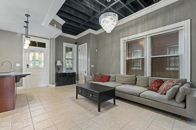 tiled living room with crown molding, sink, and an inviting chandelier