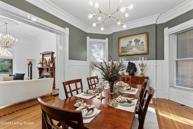 dining space featuring a chandelier, light wood-type flooring, and ornamental molding