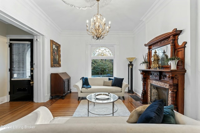 living room with light hardwood / wood-style floors, crown molding, and a chandelier