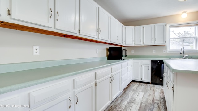 kitchen featuring dishwasher, light hardwood / wood-style flooring, white cabinetry, and sink