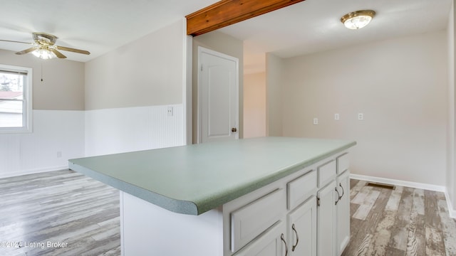 kitchen with white cabinetry, light hardwood / wood-style flooring, and ceiling fan