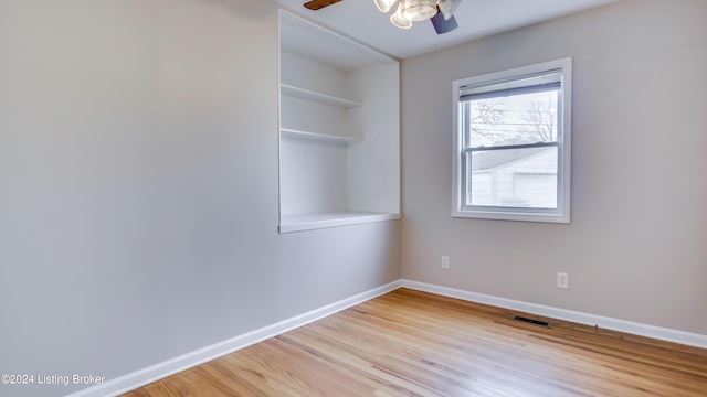 empty room featuring ceiling fan and light hardwood / wood-style flooring